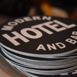 Permalink to COVID-19 Updates Stack of coasters in Boise, Idaho, branded with the modern bar and hotel logo, a black circle with white lettering.